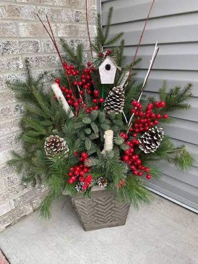 Winter container arrangement with greenery, berries and decorative accents